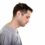 Profile view of sad young man looking down