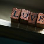 Love or Valentine’s Day Concept with Wooden Letters LOVE on a wo