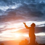 silhouette of handsome asian man praying.