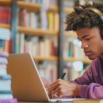 Man Working on Laptop in Library